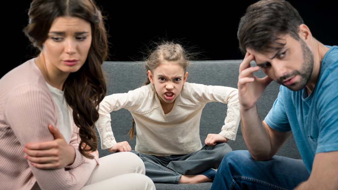 portrait of angry daughter and upset parents on black, family problems concept