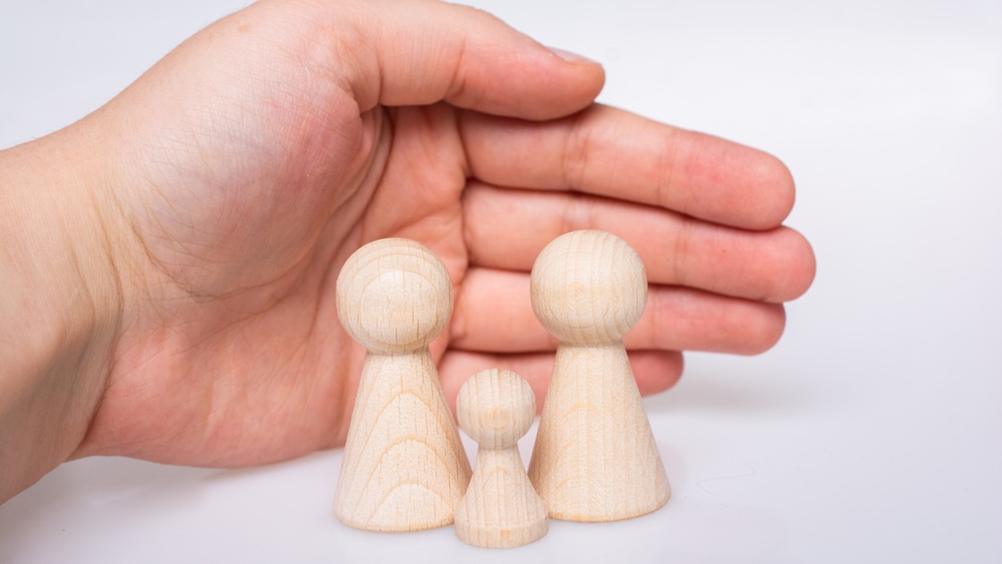 Wooden figurines of  family as concept of caring for children