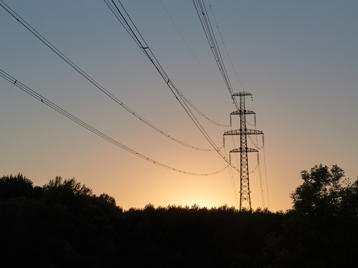 Power grid ultra high voltage electric line in sunrise light